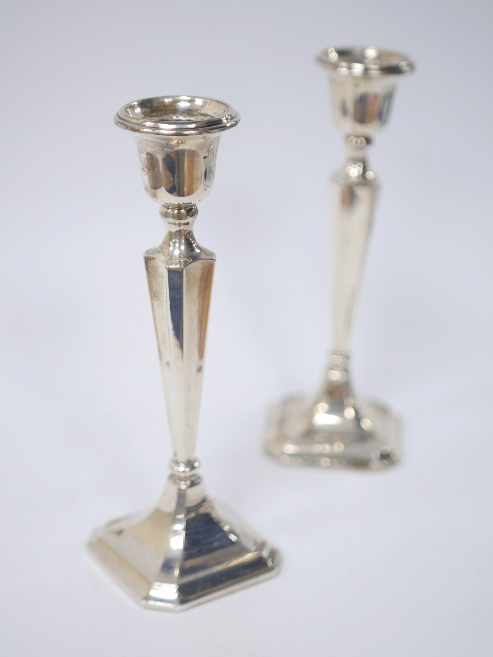 A pair of George V silver candlesticks, Birmingham, 1921, 19.9cm, weighted. Condition - poor